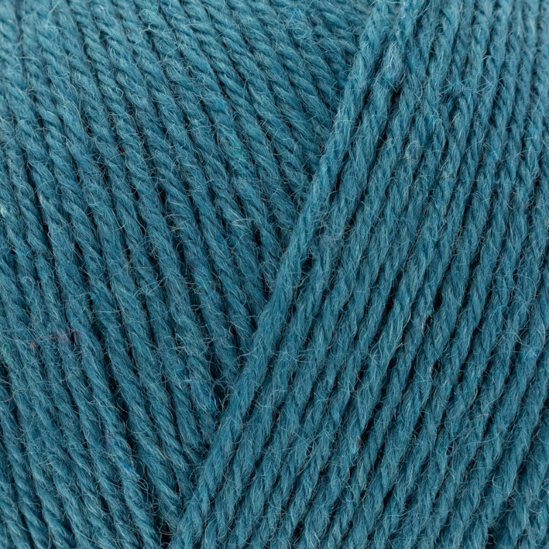 Close-up of teal yarn with visible texture