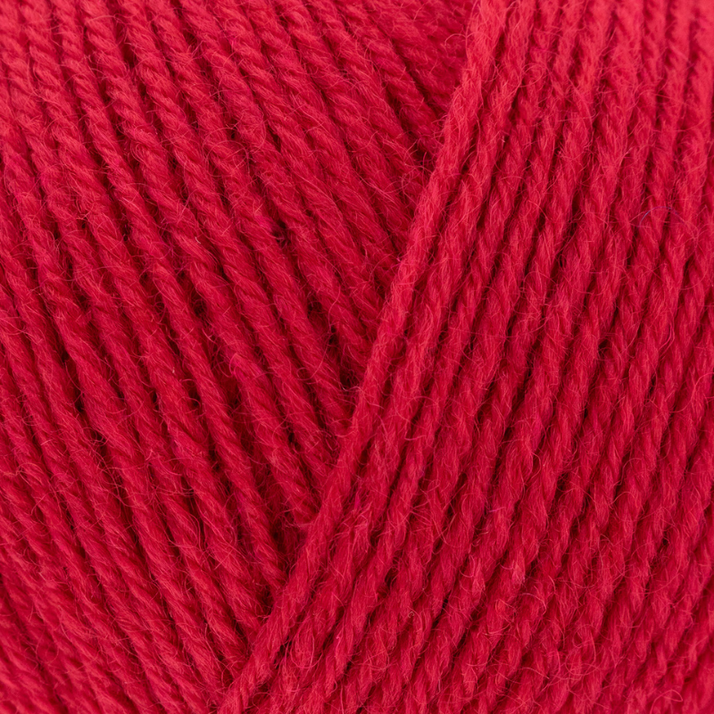 Close-up of red yarn with a visible label.