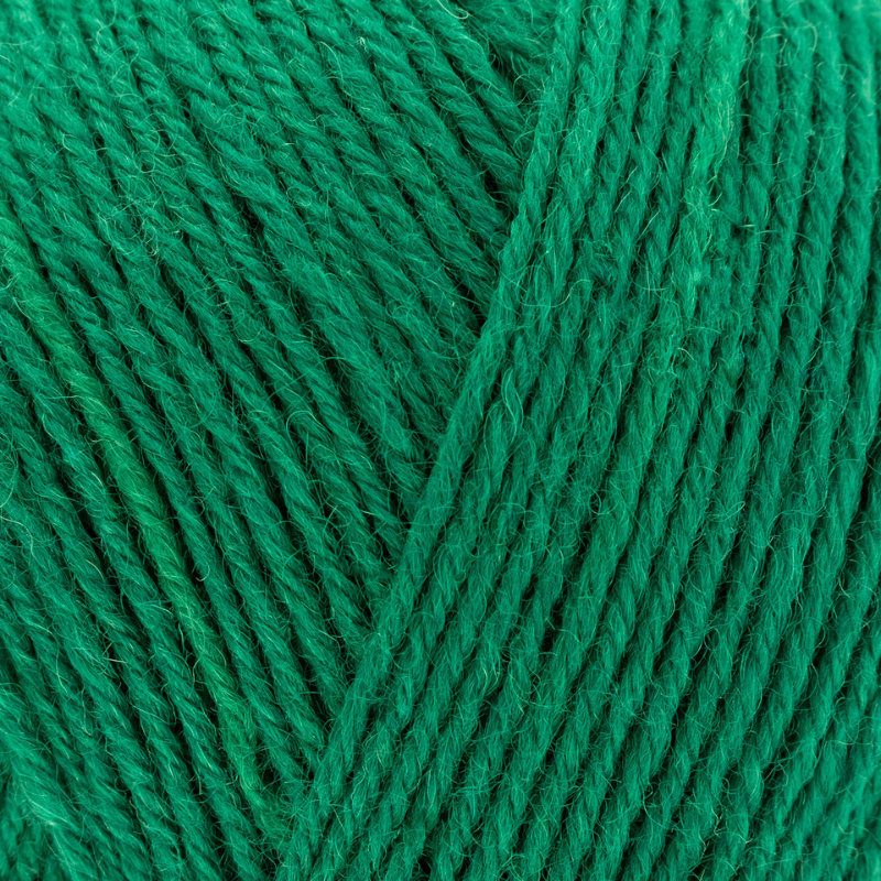 Close-up of green yarn with a visible brand label.