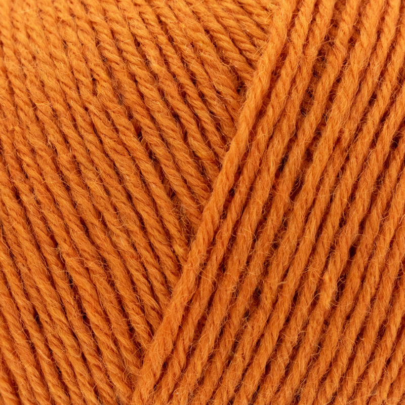 Close-up of orange yarn with a clear focus on texture