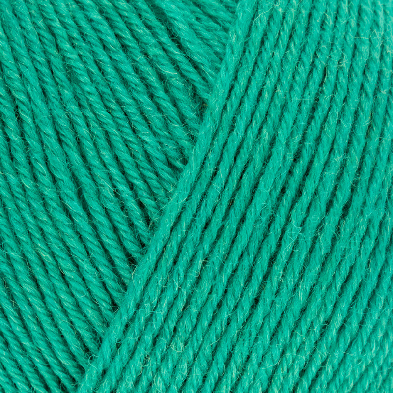 Close-up of teal yarn with a visible label