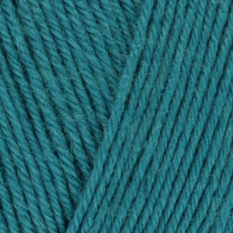 Close-up of teal yarn with a textured surface