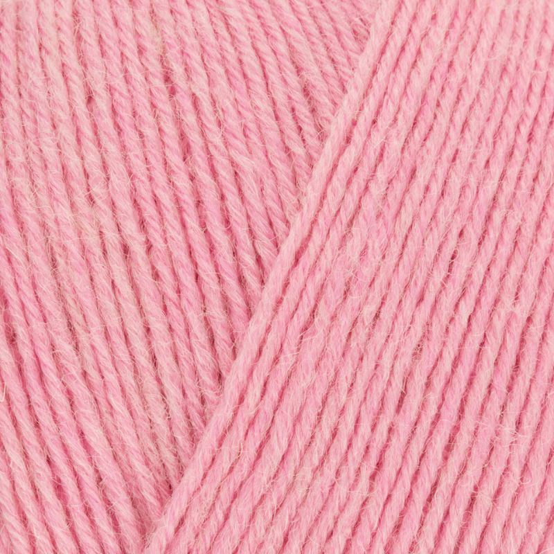 Close-up of pink yarn with a visible strand