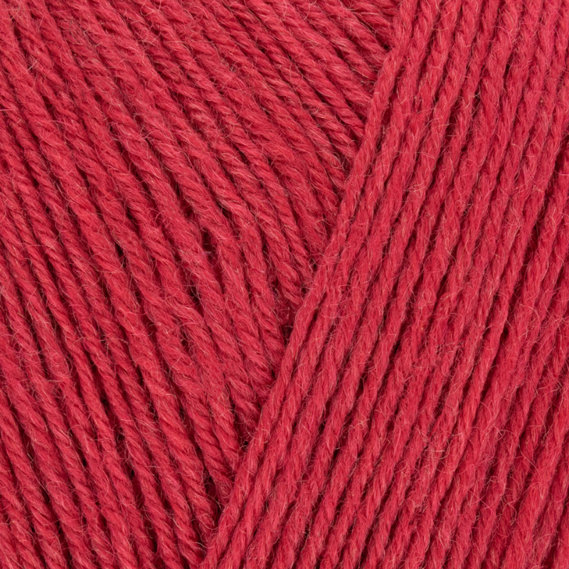 Close-up of red yarn with a visible texture