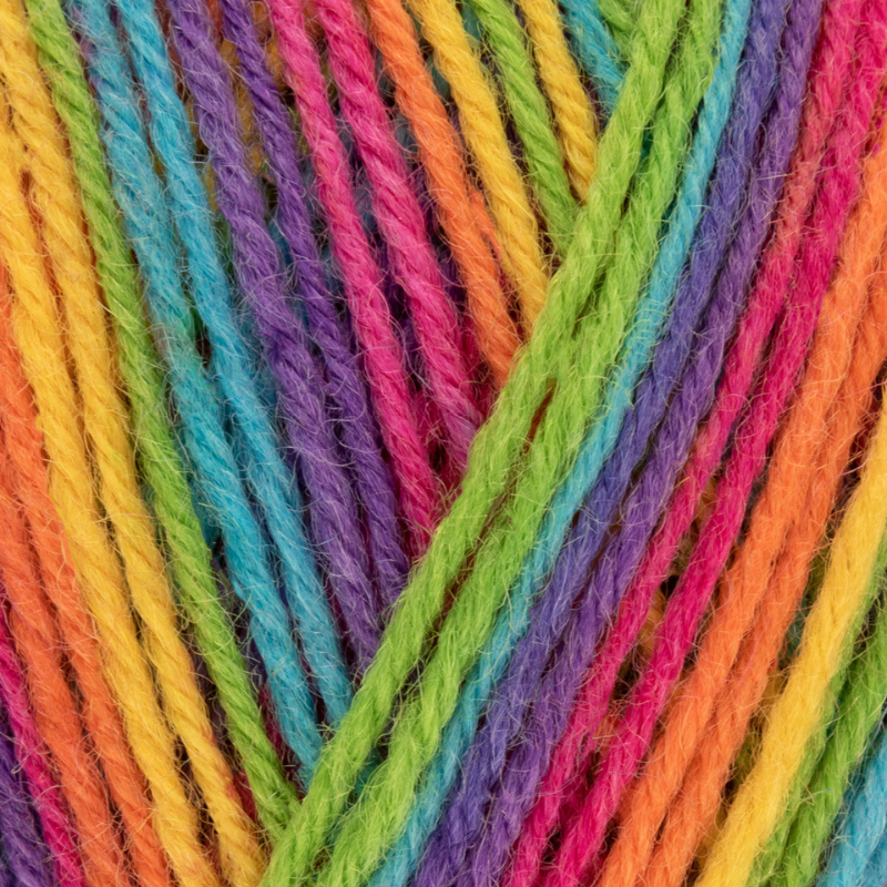 Close-up of colorful yarn strands in a rainbow pattern
