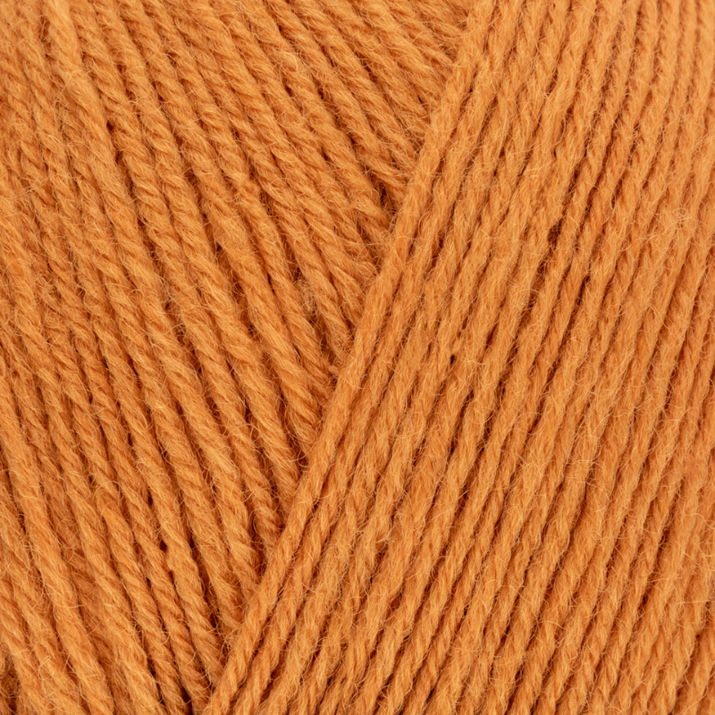Close-up of orange yarn with a diagonal pattern