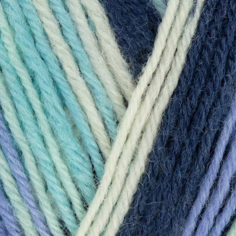 Close-up of yarn with blue, green, and beige colors.