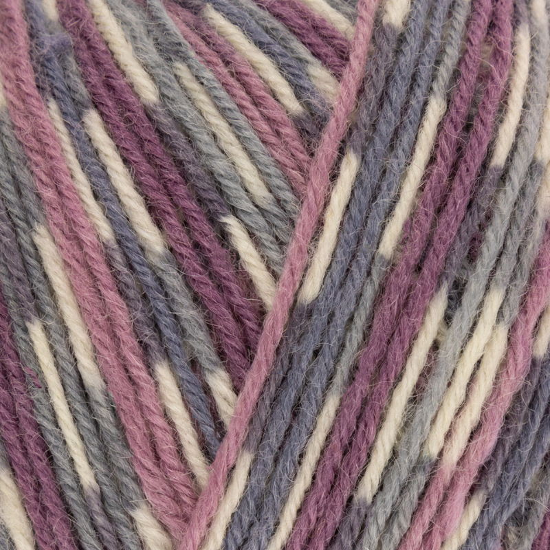 Close-up of multicolored yarn with purple, pink, and beige stripes.