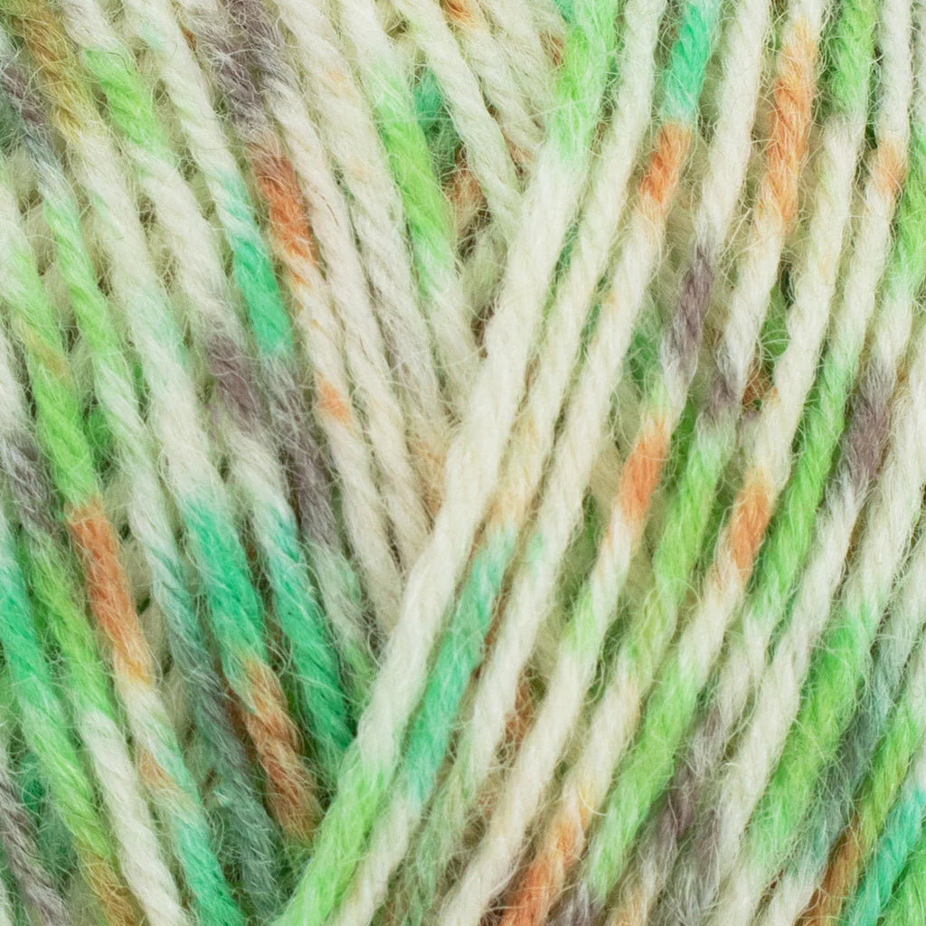 Close-up of multicolored yarn with green, orange, and beige tones.