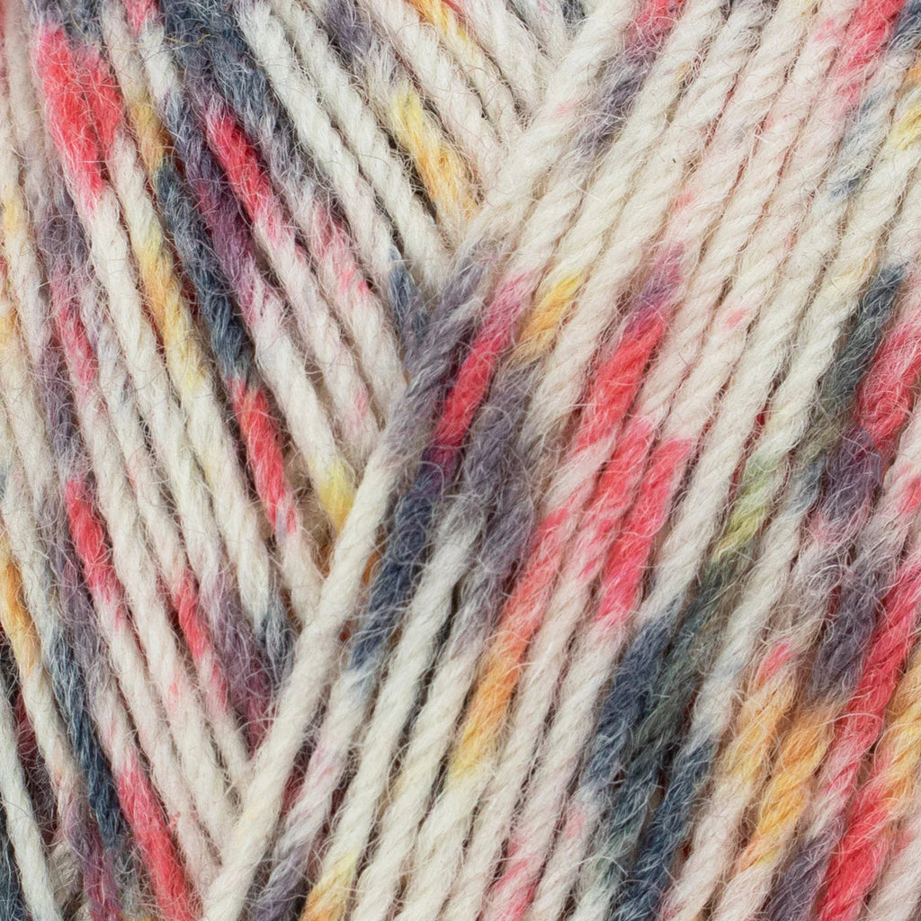 Close-up of multicolored yarn with red, yellow, and gray tones.