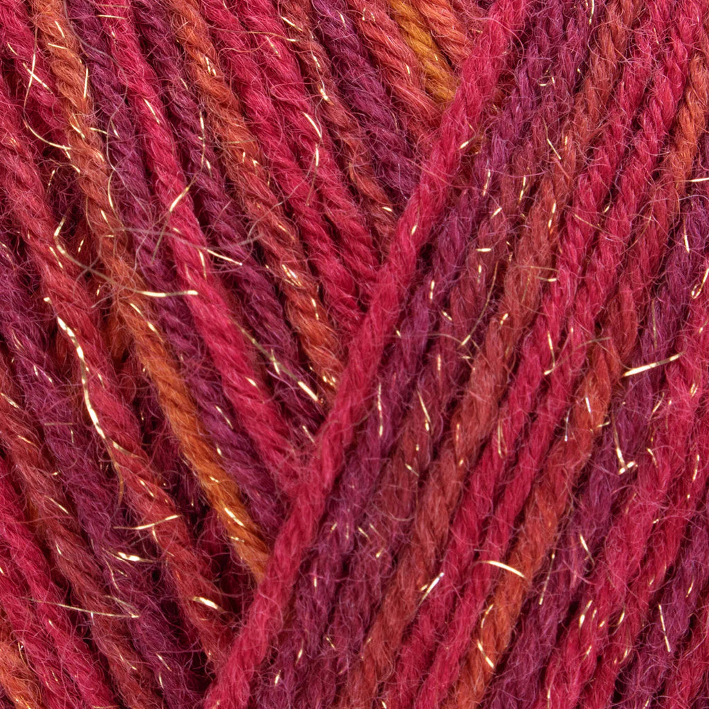 Close-up of multicolored yarn with red, orange, and purple hues.
