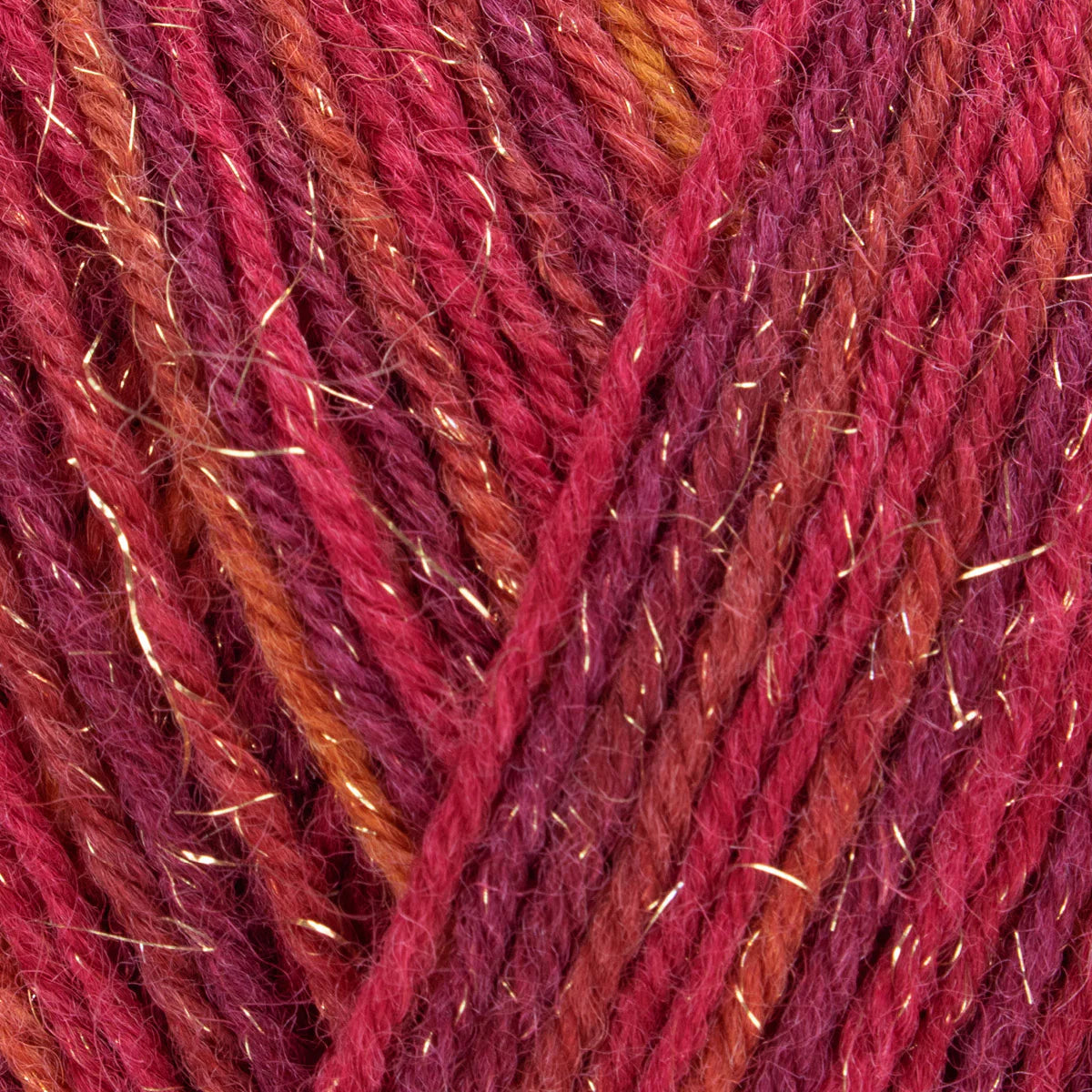 Close-up of multicolored yarn with red, orange, and purple hues.